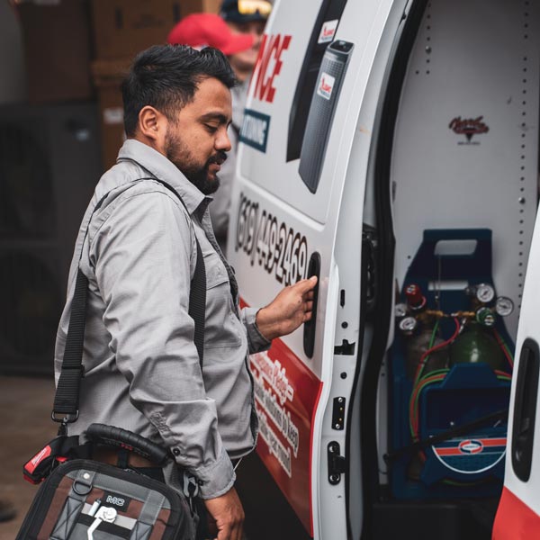 technician closing door to service van