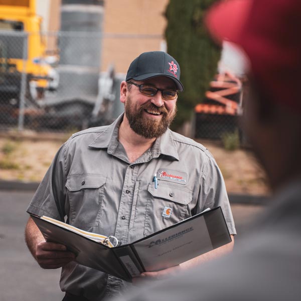 technician smiling with binder